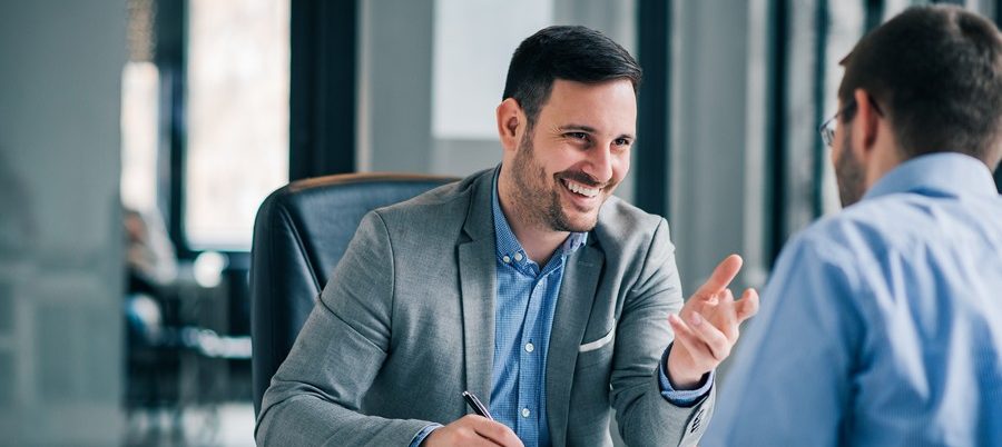 Man having a business meeting and signing a contract, recruitment or agreement.